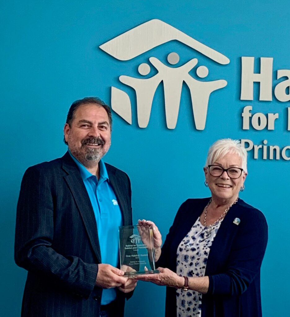 Hazzem Koudsi CEO, and Kathryn Brown Past Board Chair show off the award received from Habitat for Humanity Canada.